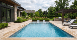 Premium travertine stone pool surround with an integrated perimeter overflow, built by a luxury pool surround contractor in Upstate New York.